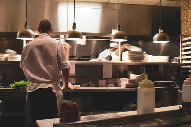Home chef standing in restaurant kitchen